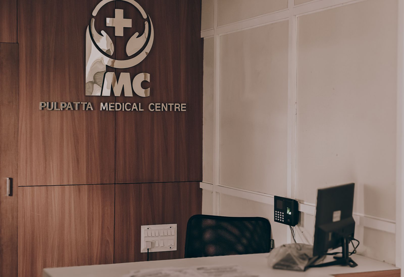 A doctor speaking with a patient in a light-filled consultation room
